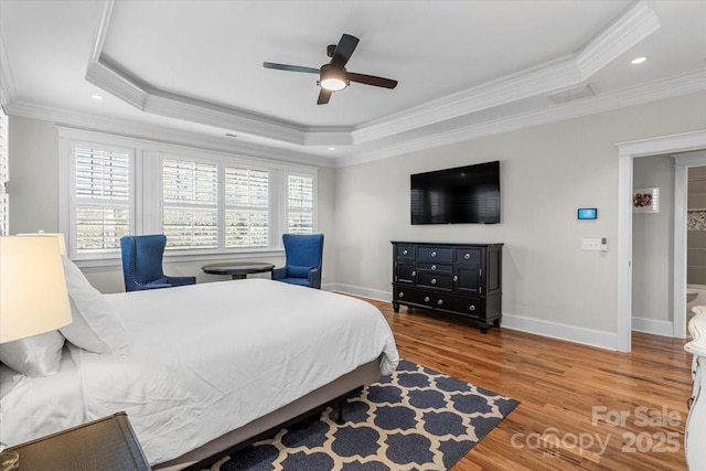 bedroom featuring a raised ceiling and crown molding