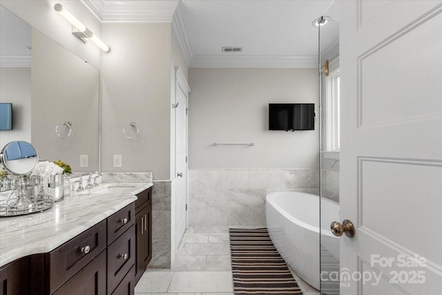 bathroom featuring tile walls, vanity, ornamental molding, a bath, and tile patterned floors