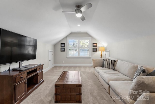 living room featuring vaulted ceiling, light carpet, and ceiling fan