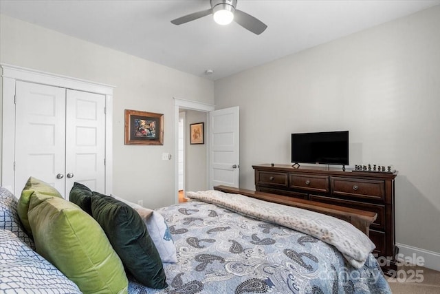 carpeted bedroom featuring a closet and ceiling fan