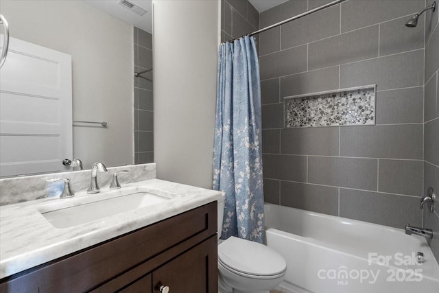 full bathroom featuring vanity, toilet, and shower / tub combo with curtain