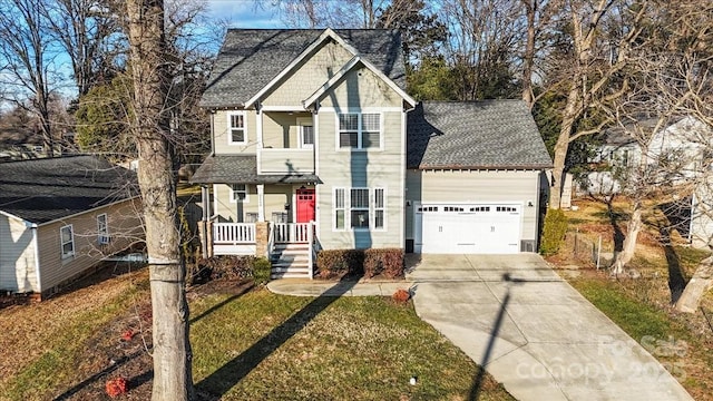 view of front of house with a garage, a porch, and a front yard