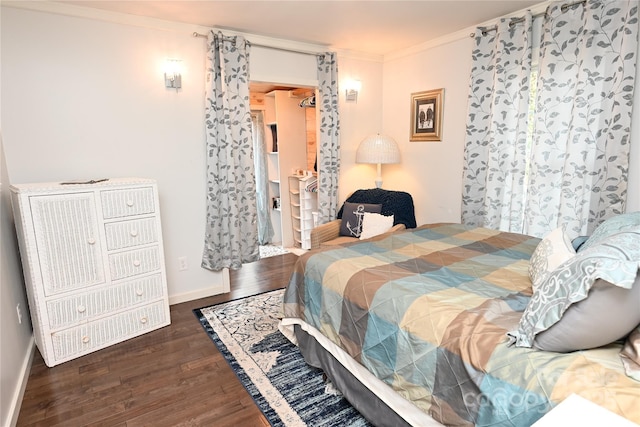 bedroom with dark wood-type flooring and ornamental molding