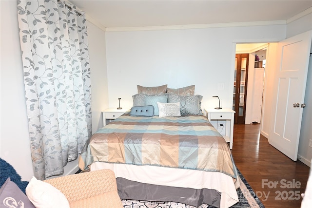 bedroom featuring crown molding and dark hardwood / wood-style floors