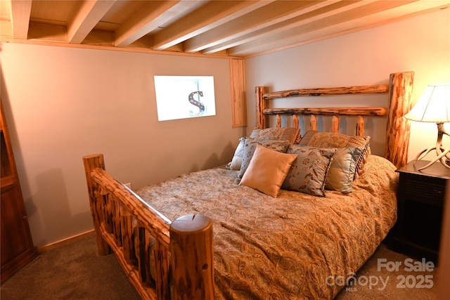 carpeted bedroom featuring beamed ceiling