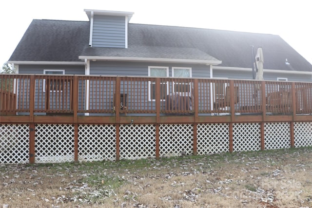 back of house featuring a wooden deck