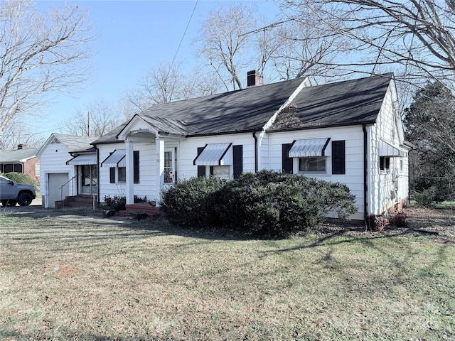 view of property exterior with a yard and a garage