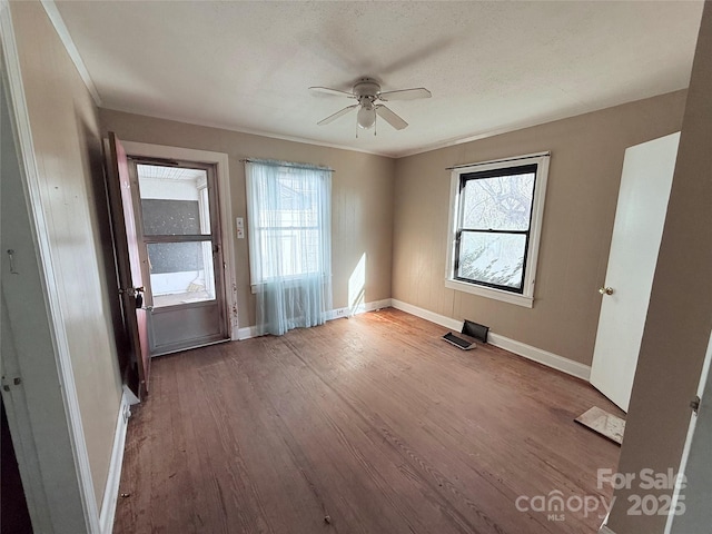 unfurnished room with crown molding, light hardwood / wood-style flooring, and ceiling fan