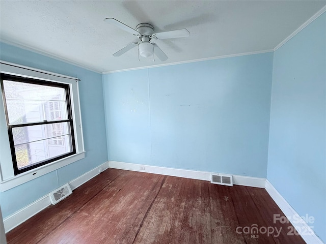 spare room featuring crown molding, dark hardwood / wood-style floors, and ceiling fan