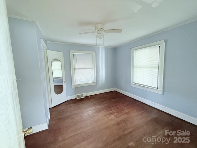 empty room featuring plenty of natural light, ornamental molding, and ceiling fan