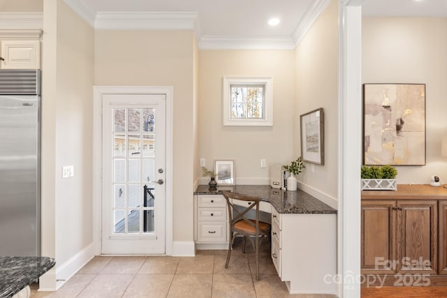 tiled home office with ornamental molding and built in desk