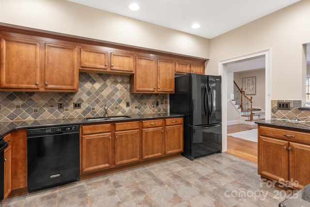 kitchen with sink, decorative backsplash, and black appliances