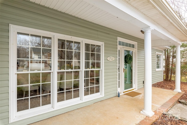 view of exterior entry with a porch