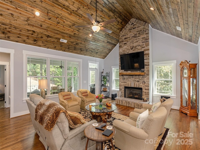 living room featuring ceiling fan, a fireplace, high vaulted ceiling, and wood-type flooring