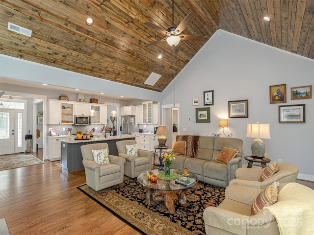 living room featuring hardwood / wood-style floors, high vaulted ceiling, sink, ceiling fan, and wood ceiling