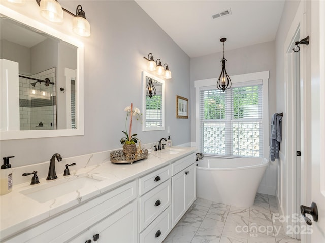 bathroom with vanity and separate shower and tub