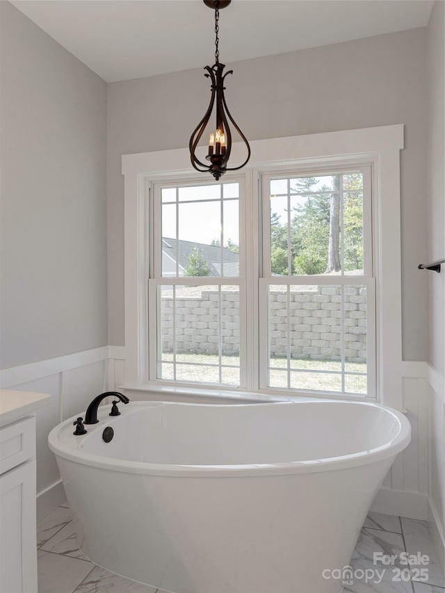 bathroom with a bathing tub and vanity