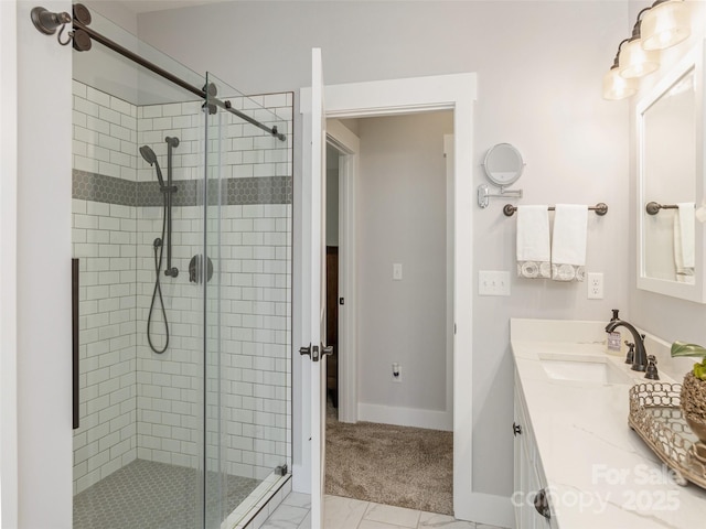 bathroom with a shower with door and vanity