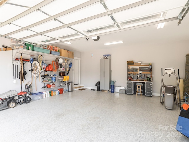 garage featuring a garage door opener and a workshop area