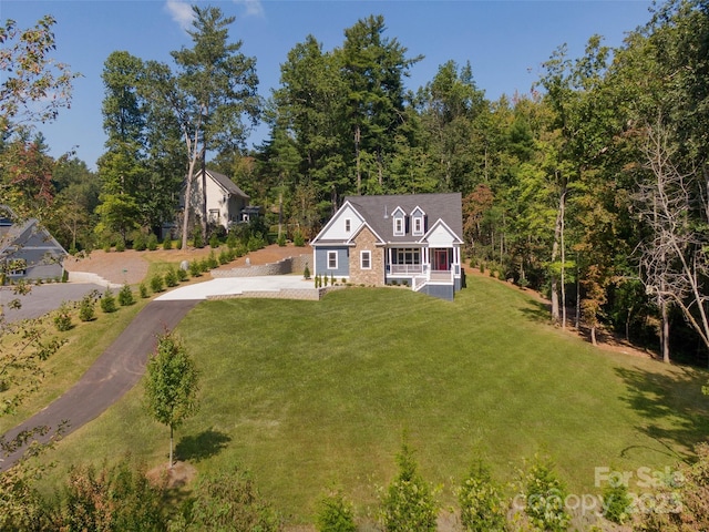 view of front of house with a front yard and covered porch