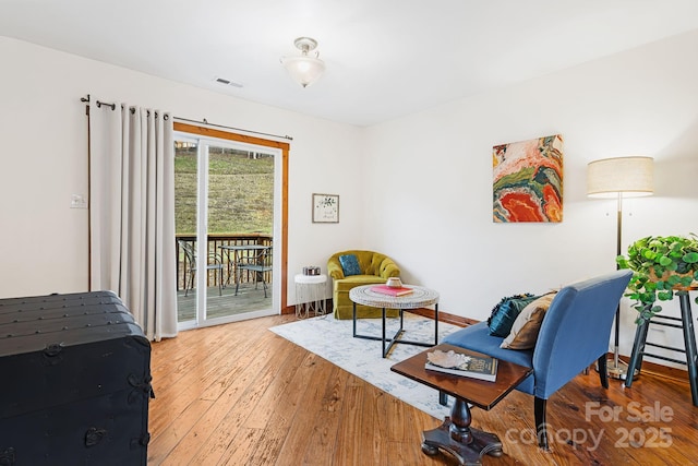 living area with hardwood / wood-style flooring