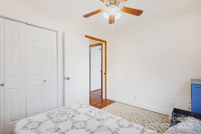 bedroom featuring ceiling fan, hardwood / wood-style floors, and a closet