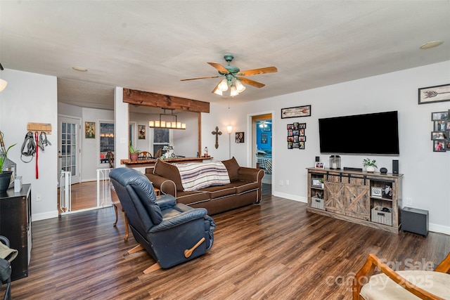 living room with dark hardwood / wood-style flooring and ceiling fan