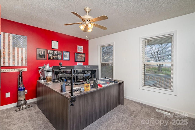 carpeted office with ceiling fan and a textured ceiling