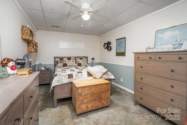 bedroom featuring crown molding, a drop ceiling, and ceiling fan