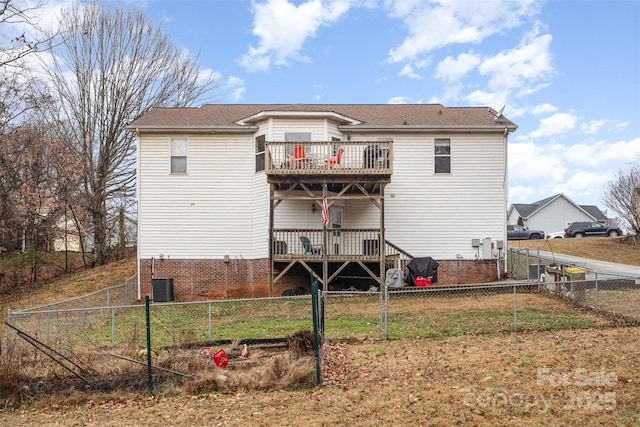 rear view of house featuring a wooden deck, a balcony, and central air condition unit