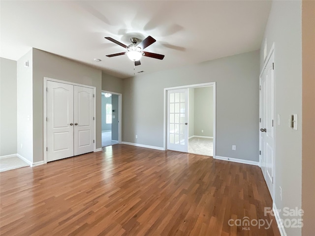 unfurnished bedroom featuring hardwood / wood-style flooring and ceiling fan