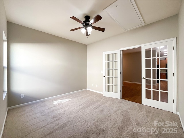 carpeted empty room featuring french doors and ceiling fan