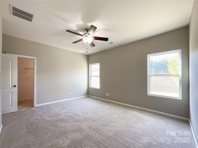 spare room with light carpet and ceiling fan