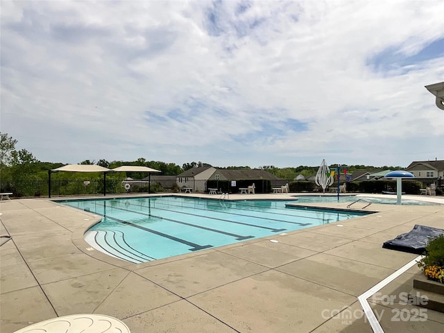 view of swimming pool with a patio