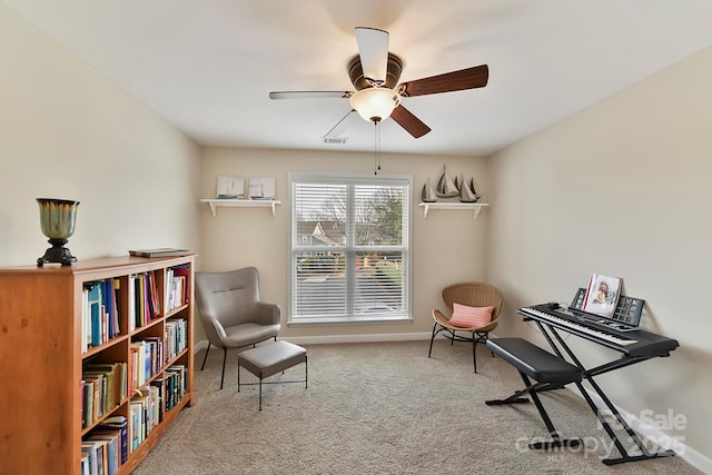 sitting room with ceiling fan and carpet flooring