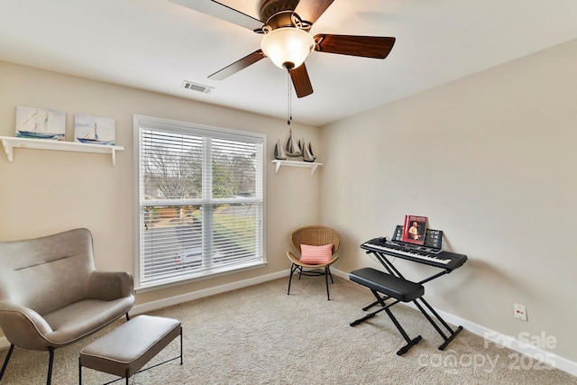 sitting room featuring ceiling fan and carpet floors