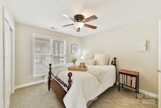 carpeted bedroom with ceiling fan and a closet