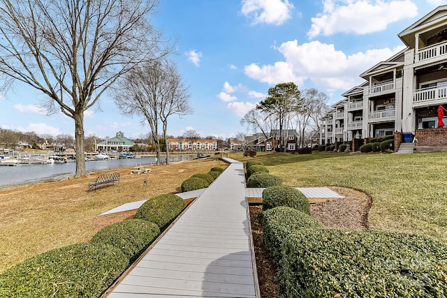 view of community with a yard and a water view