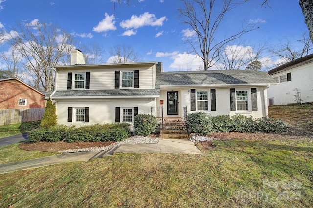 tri-level home with a front yard