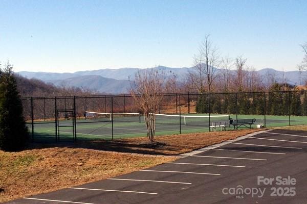 view of tennis court featuring a mountain view