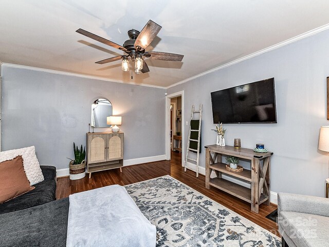 living room featuring ceiling fan, crown molding, and dark hardwood / wood-style flooring