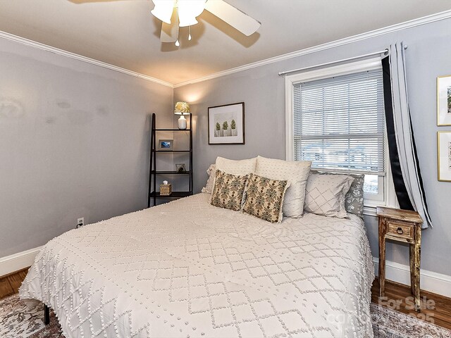 bedroom featuring crown molding, hardwood / wood-style floors, and ceiling fan