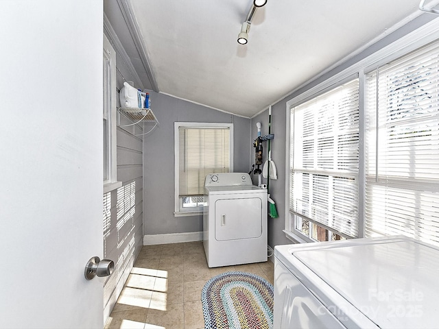 clothes washing area featuring independent washer and dryer, light tile patterned floors, and ornamental molding