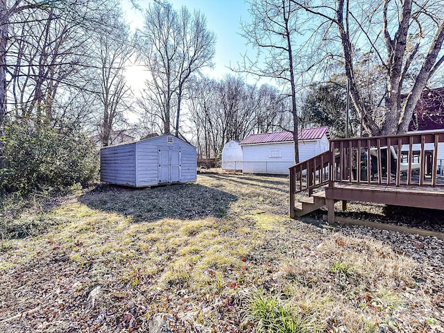 view of yard with a deck and a shed