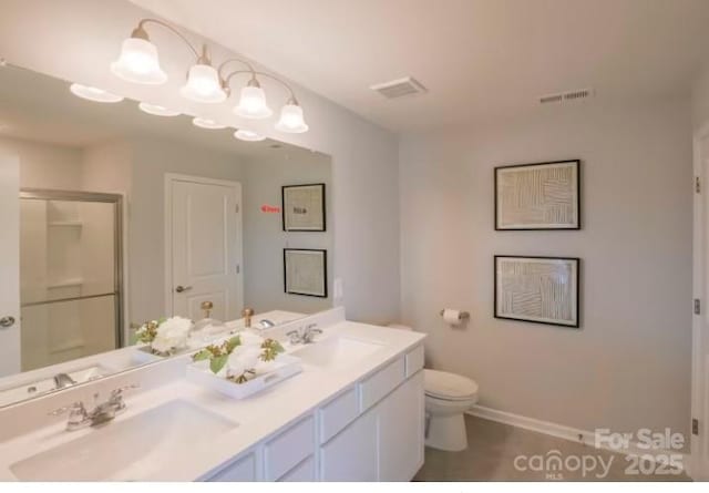 bathroom with toilet, tile patterned flooring, walk in shower, and vanity