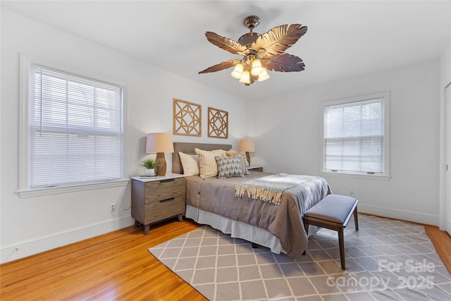 bedroom with hardwood / wood-style flooring and ceiling fan