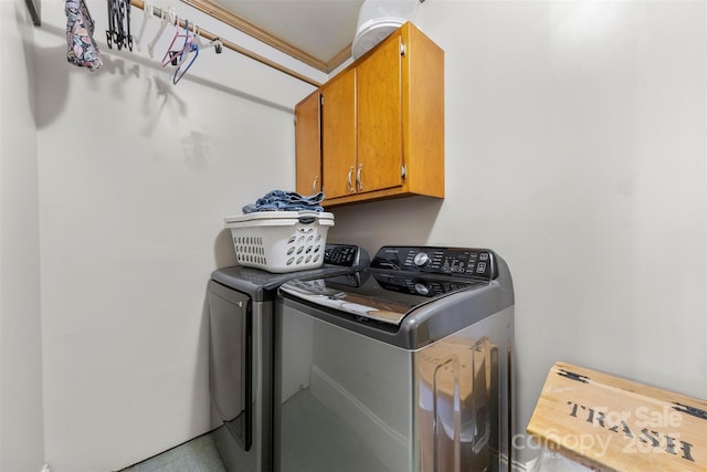 laundry area featuring cabinet space and separate washer and dryer