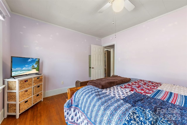 bedroom featuring ceiling fan, ornamental molding, dark wood finished floors, and baseboards