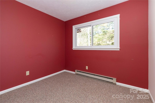 carpeted empty room with a baseboard radiator and a textured ceiling