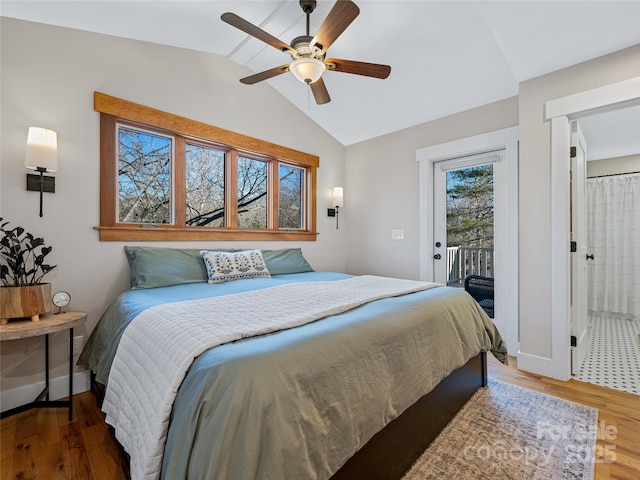 bedroom featuring wood-type flooring, access to exterior, lofted ceiling, and ceiling fan